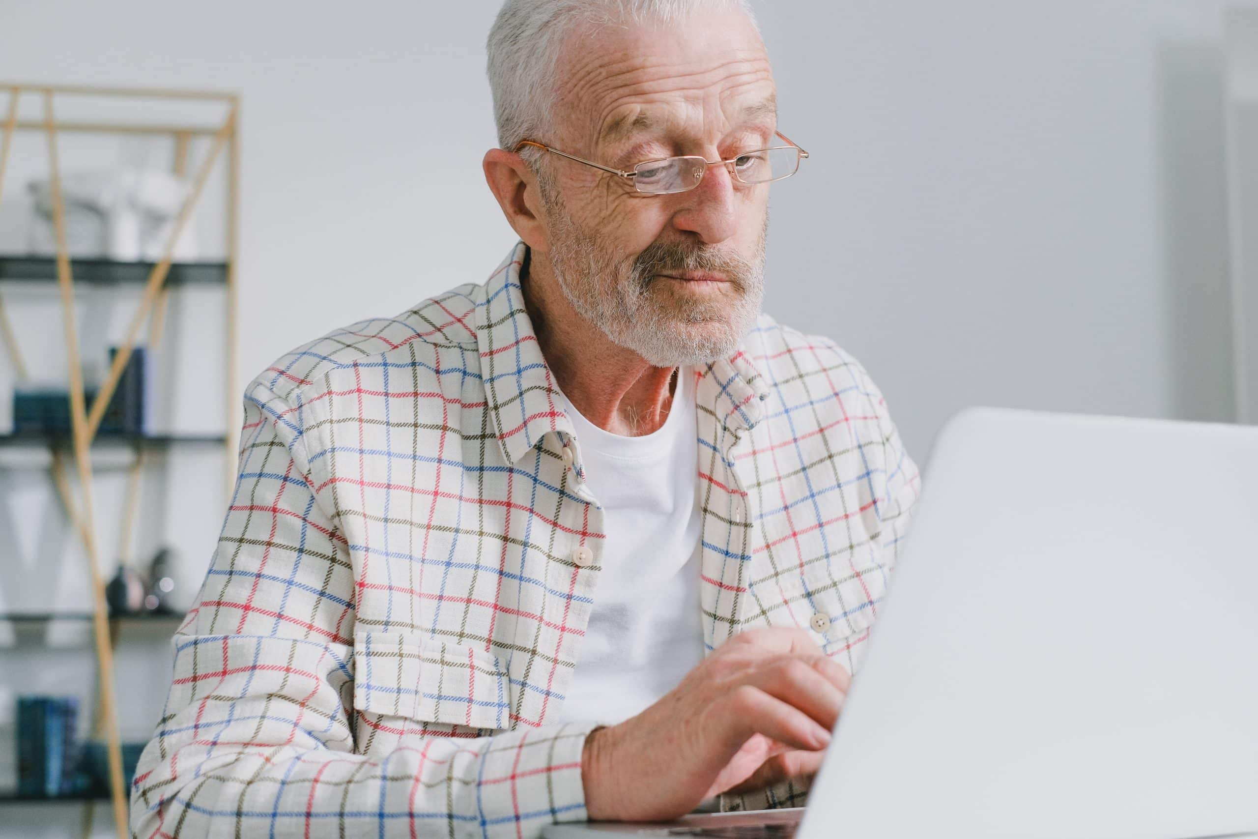 oudere man achter laptop supplement